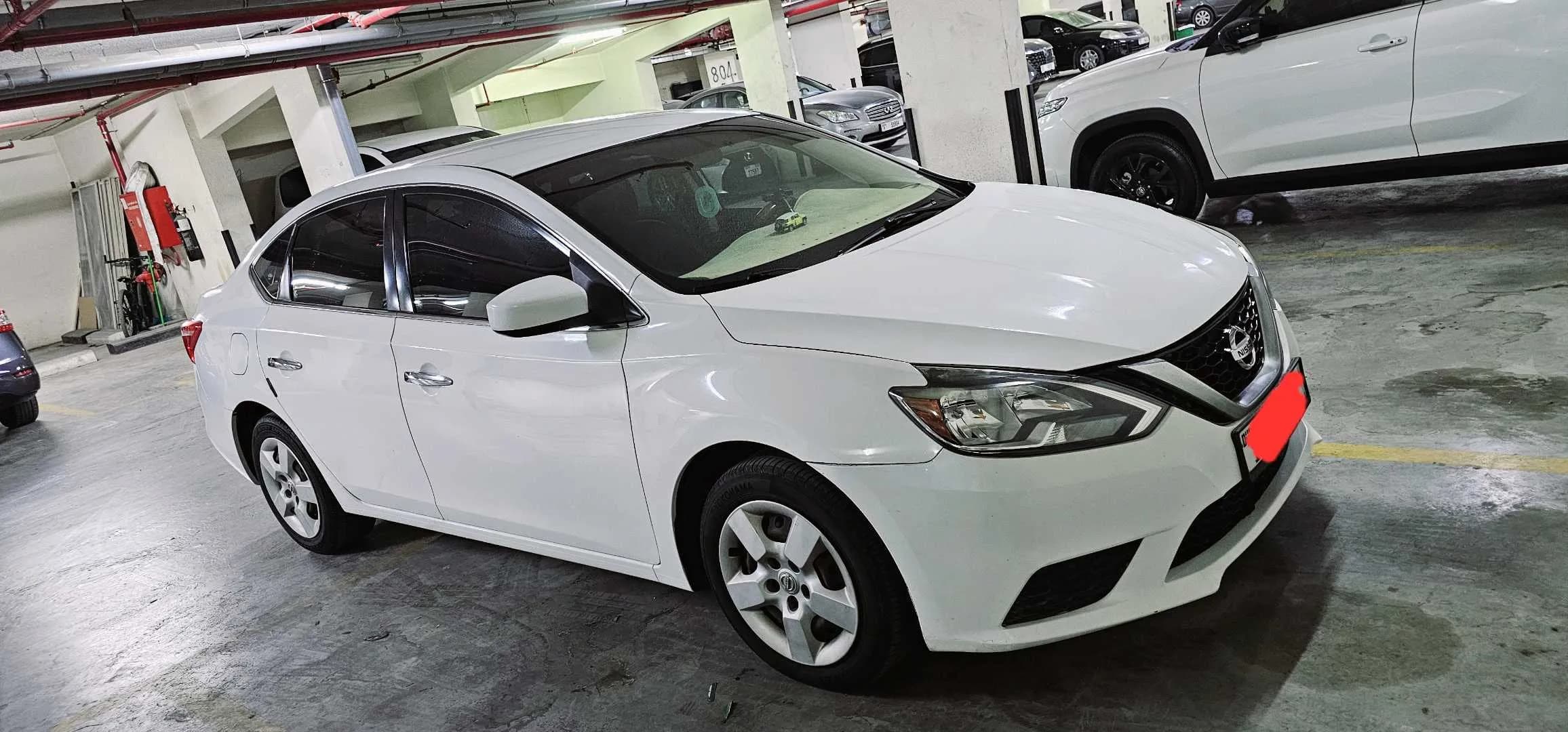 URGENT SALE *NISSAN SENTRA — FAMILY CAR-FOR SALE (PREMIUM EDITION)*, DUBAI NUMBER PLATE, BUY AND DRIVE, LADY OWNER, ORIGINAL WHITE COLOR photo 1